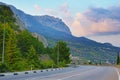 Road at mountainside with view of cliff and clouds Royalty Free Stock Photo