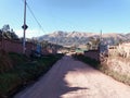 road near houses and distant mountain Royalty Free Stock Photo