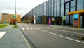 Road near expo and convention business centre Expoforum. Glass exterior wall and orange color office building architecture. Indust