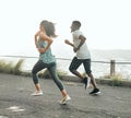 The road never judges you. Shot of two friends running together.