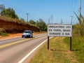 Road with a new traffic sign informing the new law that requires the use of headlights on even during the day on the roads with a Royalty Free Stock Photo