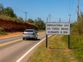 Road with a new traffic sign informing the new law that requires the use of headlights on even during the day on the roads with a Royalty Free Stock Photo