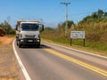 Road with a new traffic sign informing the new law that requires the use of headlights on even during the day on the roads with a