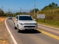 Road with a new traffic sign informing the new law that requires the use of headlights on even during the day on the roads with a Royalty Free Stock Photo