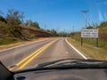 Road with a new traffic sign informing the new law that requires the use of headlights on even during the day on the roads seen fr Royalty Free Stock Photo