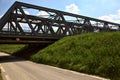 Road that passes under a railway bridge on a clear day in spring in the italian countryside Royalty Free Stock Photo