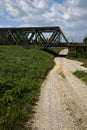 Road that passes under a railway bridge on a clear day in spring in the italian countryside Royalty Free Stock Photo