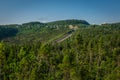 An american road into the forest by the sea