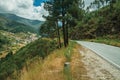 Road passing through hilly landscape and a village in the valley Royalty Free Stock Photo