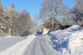 Road passing a red barn in winter countryside Royalty Free Stock Photo