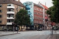 Road passing the red buildings with wall graffiti in Norrebro and Nord Vest district in Copenhagen Royalty Free Stock Photo