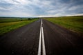 Asphalt road with fresh markings rests against the clouds Royalty Free Stock Photo