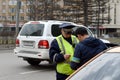 The road patrol service inspector of the police checks the documents of a taxi driver in Central Moscow.