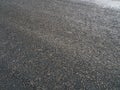 A road paved with tar, asphalt road made of small pebble stones