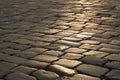 The road paved with traditional granite paving stones. ray stones