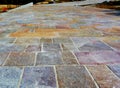 sidewalk construction progress with terracotta style stone tiles