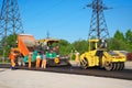 Road paving with truck, rolling machinery and workers