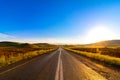 Road in the plain vanishing on the horizon and morning sun in summer Royalty Free Stock Photo