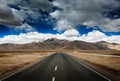 Road on plains in Himalayas with mountains Royalty Free Stock Photo