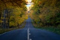 Road through the Porcupine Mountains in the Upper Peninsula in Michigan during the fall. Concept for fall leaf peeping road trip Royalty Free Stock Photo