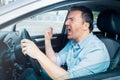 Road rage man at the wheel threatening other drivers Royalty Free Stock Photo