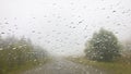 Road in rainy cloudy weather through the windshield of the car Royalty Free Stock Photo