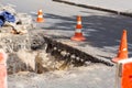 Road repair work pit fenced with orange cones. Royalty Free Stock Photo