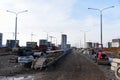 Road repair works at construction site. Construction road of city street  in a new residential quarter. Asphalt paver machine and Royalty Free Stock Photo