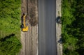 Road repairs. Excavator bucket removes soil along the roadbed Royalty Free Stock Photo