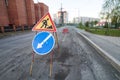 Road repairs, road signs and a bunch of crushed stone on the road Royalty Free Stock Photo