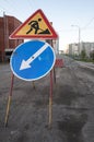 Road repairs, road signs and a bunch of crushed stone on the road Royalty Free Stock Photo