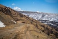 Road from a repeater on snowy tops of Altai mountains near Aktash town, Russia