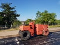 Road roller and asphalt compactor parked on the side of the road during lunch break Royalty Free Stock Photo