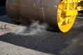 Road roller compacting asphalt during road repairs. Royalty Free Stock Photo