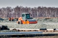 Road roller dredges rubble on road construction Royalty Free Stock Photo