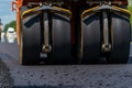 Road roller flattening new asphalt. Heavy vibration roller at work paving asphalt, road repairing. Selective focus. Royalty Free Stock Photo