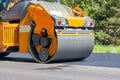 Road roller flattening new asphalt