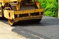 Road roller laying fresh asphalt