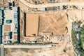 Road roller is leveling and compacting soil on construction site. drone aerial photo Royalty Free Stock Photo