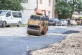 Road roller makes the paving.Close view on the road roller working on the road construction site