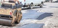Road roller makes the paving.Close view on the road roller working on the road construction site Royalty Free Stock Photo