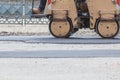 Road roller makes the paving.Close view on the road roller working on the road construction site Royalty Free Stock Photo
