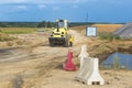 Road roller moves along a country road