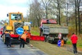Road-roller and repair team make a repair of the asphalted road Royalty Free Stock Photo