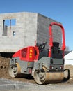 Road roller for a road in front of a house under construction Royalty Free Stock Photo
