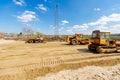 Road roller with spikes and truck plate compactor are working at construction site