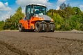 Road roller working on the new road construction site. Laying a new asphalt on the road. Construction of the road Royalty Free Stock Photo