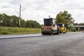 Road rollers compacting new asphalt layer during road construction on countryside highway Royalty Free Stock Photo