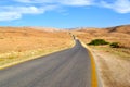Road rolling through the countryside, view of the desert and mountains in Jordan Royalty Free Stock Photo