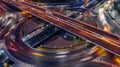 Road roundabout intersection in the city at night with vehicle car light movement, Aerial view Royalty Free Stock Photo